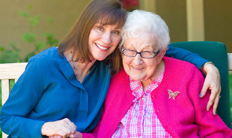 Dr. Maribeth Gallagher, director HOV's Dementia Program visits with dementia patient Sue Crawford, 100, at Gardiner Home.