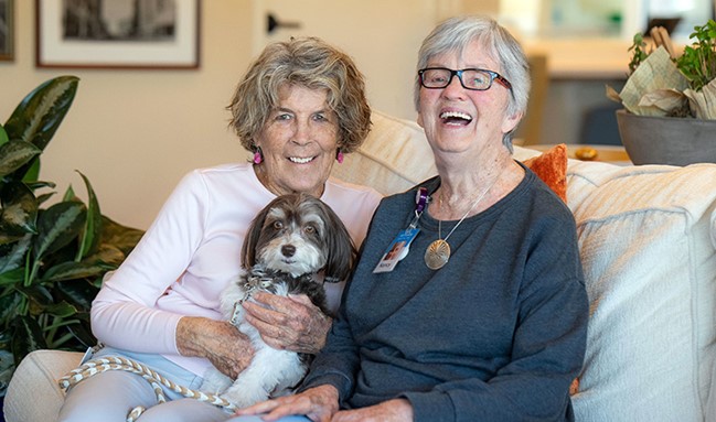 Pet therapy team Nancy Kelso and Coco Chanel visit patient Nancy Clark at the Dementia Care and Education Campus.