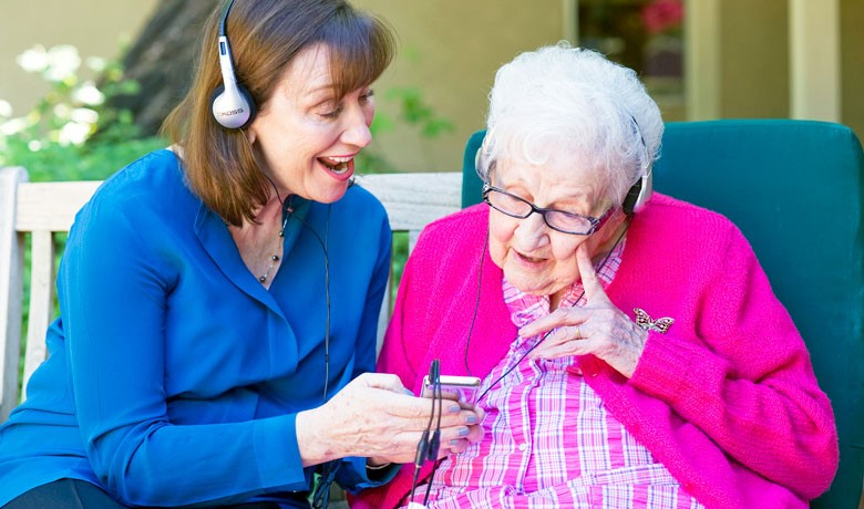 Dr. Maribeth Gallagher, director HOV's Dementia Program visits with dementia patient Sue Crawford at Gardiner Home.