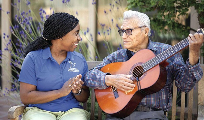 Patient playing guitar for caretaker
