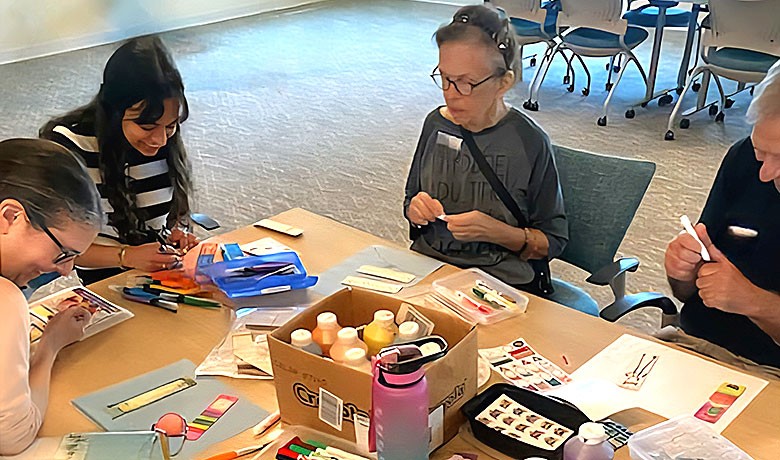 Volunteers help dementia patients with crafts
