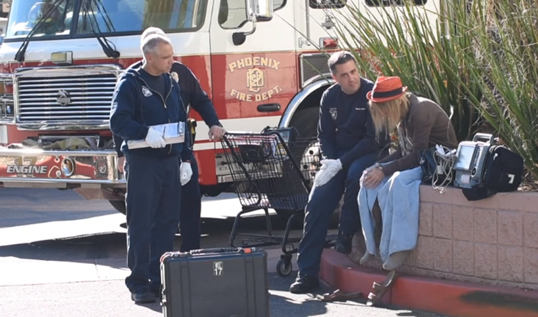 Firefighters helping homeless person