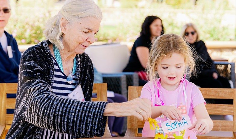 Susan and Sophia play with dinosaurs